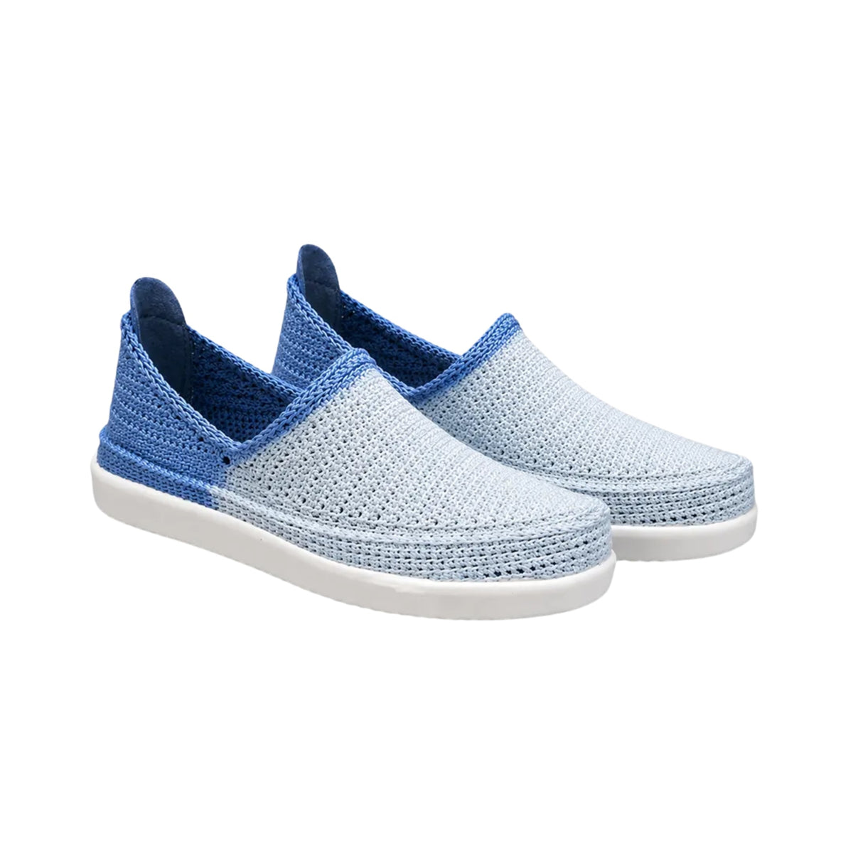 A pair of slip-on knit shoes with a light blue and white textured upper, a medium blue heel section, and a dark blue lining, set against a plain white background.