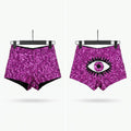 Two pairs of high-waisted, sparkly magenta-purple sequin shorts displayed side by side on black hangers against a light gray background. The left pair has a solid sequin texture, and the right pair features a large black and white eye graphic on the front.